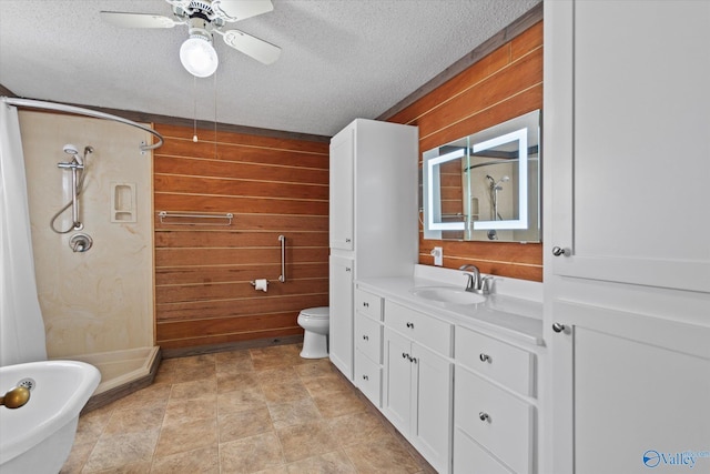 bathroom featuring vanity, a textured ceiling, wooden walls, and a shower stall