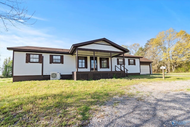 view of front of house featuring an attached garage, ac unit, driveway, a front lawn, and covered porch