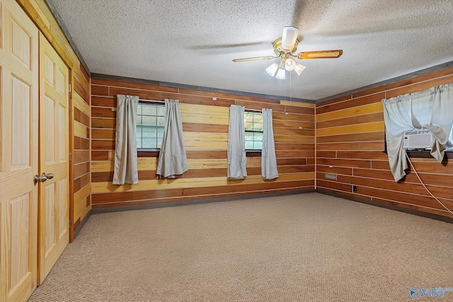 empty room featuring carpet flooring, ceiling fan, and a textured ceiling