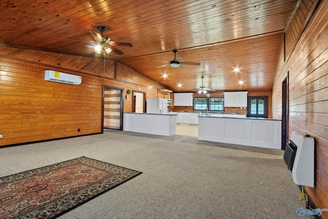 interior space featuring heating unit, light colored carpet, lofted ceiling, and a wall mounted air conditioner