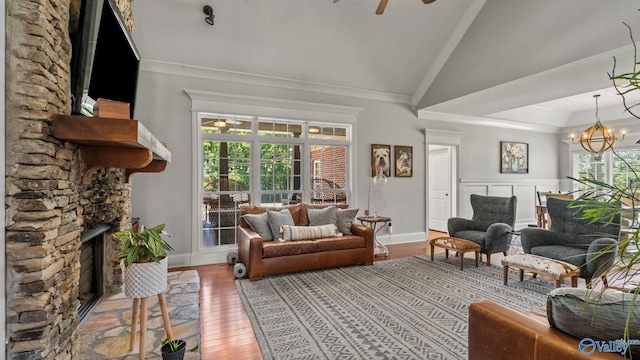 1943 Old Big Cove Rd SE, Owens Cross Roads, AL 35763 - living room featuring baseboards, wood finished floors, a chandelier, a fireplace, and high vaulted ceiling