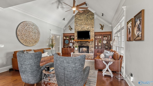 1943 Old Big Cove Rd SE, Owens Cross Roads, AL 35763 - living area featuring a ceiling fan, wood finished floors, a fireplace, baseboards, and high vaulted ceiling
