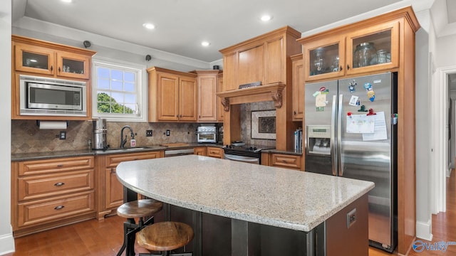 1943 Old Big Cove Rd SE, Owens Cross Roads, AL 35763 - kitchen with a sink, stainless steel appliances, backsplash, a center island, and wood finished floors
