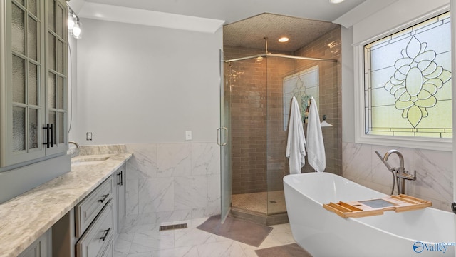 1943 Old Big Cove Rd SE, Owens Cross Roads, AL 35763 - bathroom featuring tile walls, a stall shower, a soaking tub, recessed lighting, and vanity