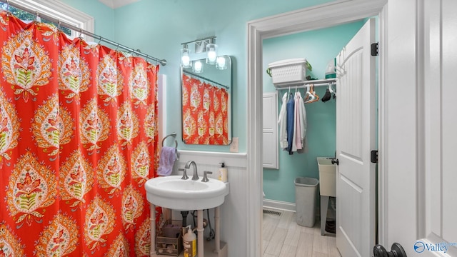 1943 Old Big Cove Rd SE, Owens Cross Roads, AL 35763 - full bathroom featuring a shower with shower curtain, a sink, and baseboards