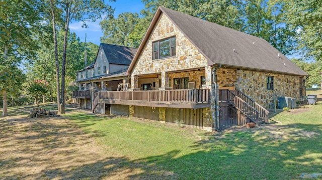 rear view of house with central AC, a lawn, and a deck