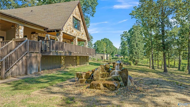 view of yard featuring ceiling fan and a wooden deck