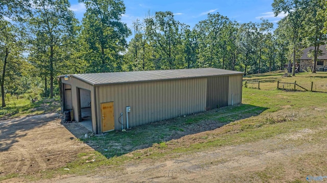 view of outdoor structure featuring a lawn and a garage