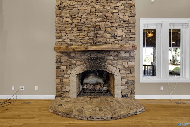 room details with hardwood / wood-style floors and a fireplace