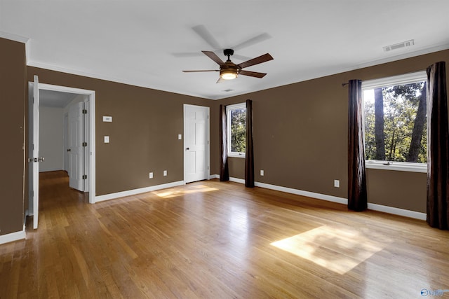 spare room featuring light hardwood / wood-style flooring, ceiling fan, and ornamental molding