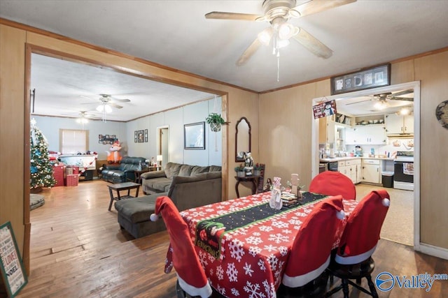 dining room with wood-type flooring and crown molding