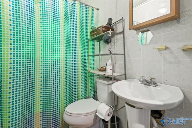 bathroom with walk in shower, tile walls, and toilet