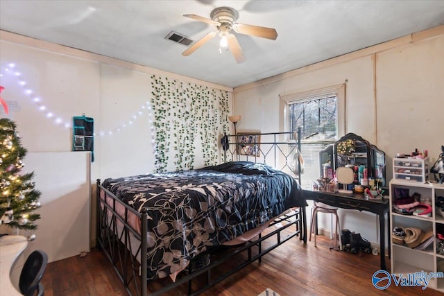 bedroom with ceiling fan and dark wood-type flooring