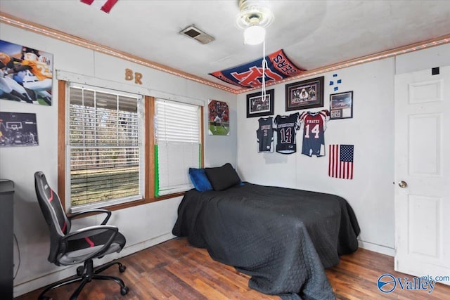 bedroom featuring ceiling fan and dark hardwood / wood-style flooring