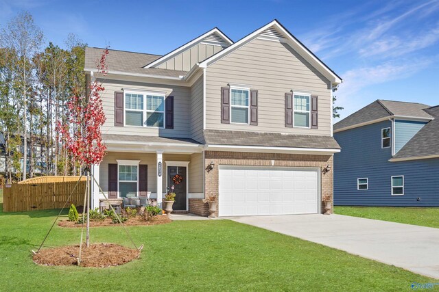 craftsman-style home featuring a garage and a front yard