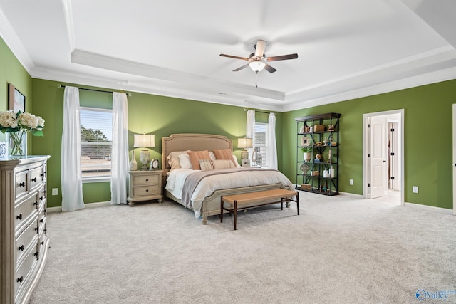 bedroom with ceiling fan, ornamental molding, a raised ceiling, and light carpet