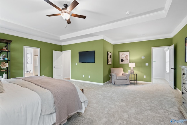 bedroom featuring ceiling fan, ornamental molding, a tray ceiling, and light carpet