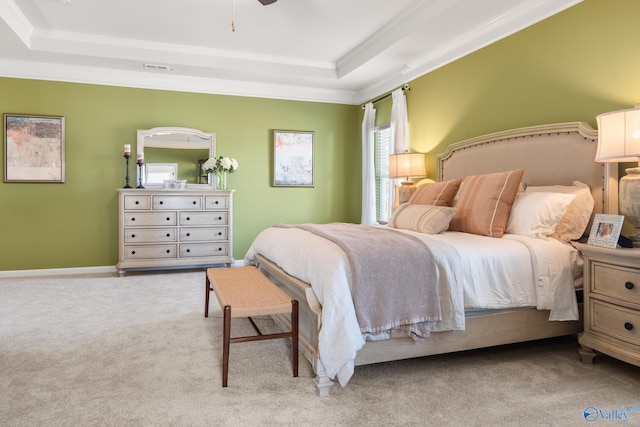 bedroom featuring a raised ceiling, crown molding, light carpet, and ceiling fan