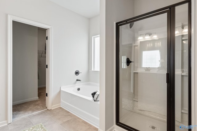 bathroom featuring plus walk in shower and tile patterned floors