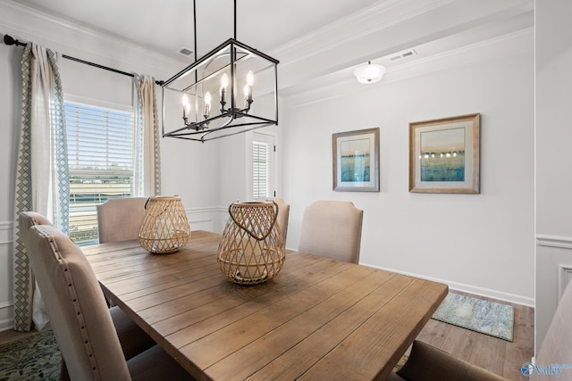 dining room with ornamental molding and wood-type flooring