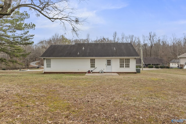 rear view of property featuring a patio area, a yard, and central AC unit