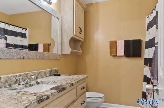 bathroom with toilet and vanity