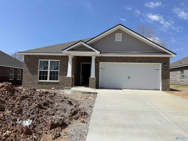 6235 Pisgah Dr NW, Huntsville, AL 35810 - view of front of house featuring a garage, brick siding, and concrete driveway