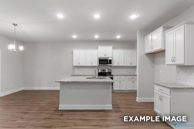 kitchen with a sink, white cabinets, backsplash, and stainless steel appliances
