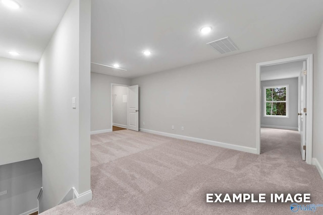 carpeted spare room featuring recessed lighting, visible vents, and baseboards