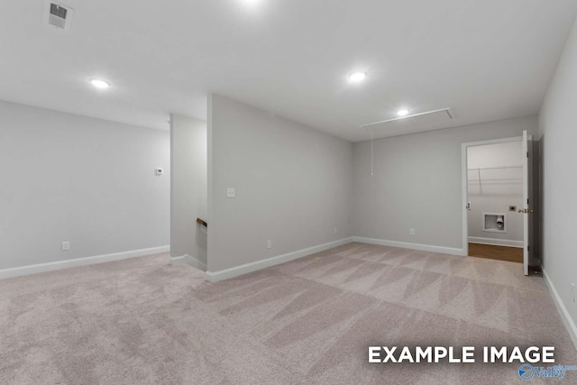 basement with visible vents, recessed lighting, light carpet, and baseboards
