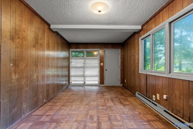 10101 Westleigh Dr, Huntsville, AL 35803 - unfurnished room with a baseboard heating unit, a textured ceiling, and wooden walls