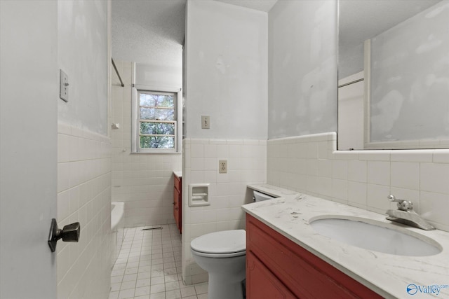 10101 Westleigh Dr, Huntsville, AL 35803 - bathroom with tile walls, vanity, tile patterned floors, shower / bath combination, and wainscoting