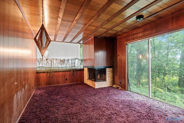 10101 Westleigh Dr, Huntsville, AL 35803 - unfurnished living room with wooden walls, a brick fireplace, carpet floors, and a wooden ceiling with exposed beams
