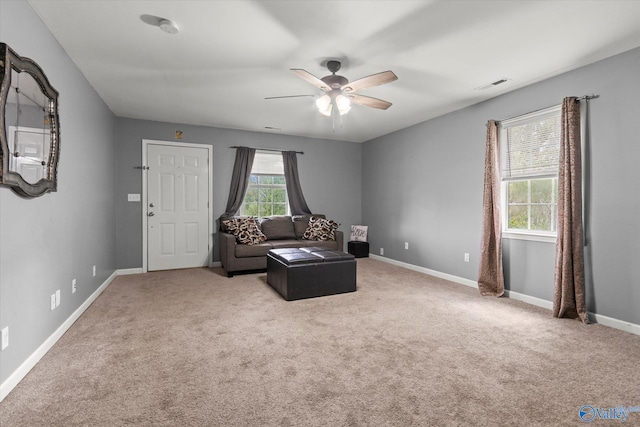 sitting room with ceiling fan and carpet floors