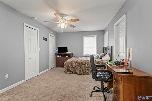 bedroom featuring ceiling fan and light carpet