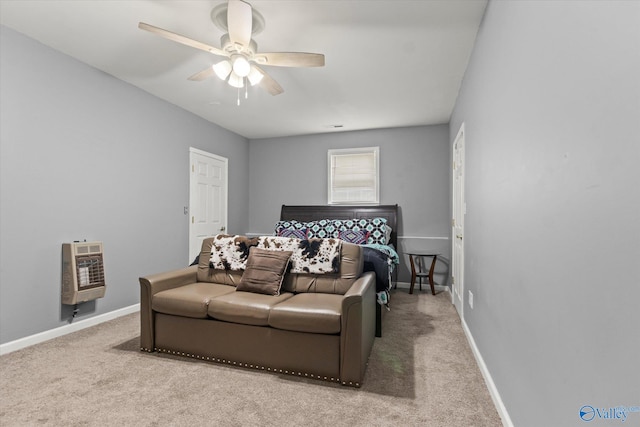 bedroom featuring ceiling fan, heating unit, and carpet floors