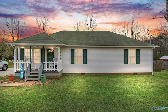 single story home featuring roof with shingles, covered porch, and a front yard