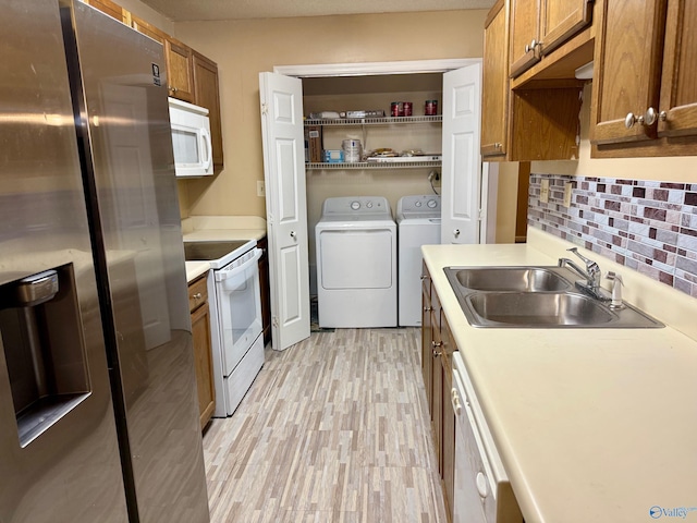 5070 Seven Pine Cir Ground, Unit Ground, Huntsville, AL 35816 - kitchen with white appliances, a sink, washing machine and dryer, and brown cabinetry
