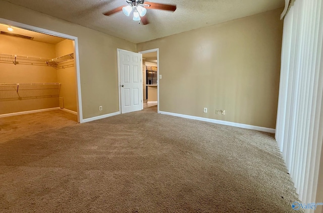 5070 Seven Pine Cir Ground, Unit Ground, Huntsville, AL 35816 - unfurnished bedroom featuring baseboards, carpet flooring, a spacious closet, a textured ceiling, and a closet