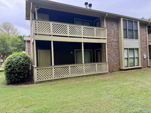 5070 Seven Pine Cir Ground, Unit Ground, Huntsville, AL 35816 - rear view of house featuring a balcony, brick siding, and a yard