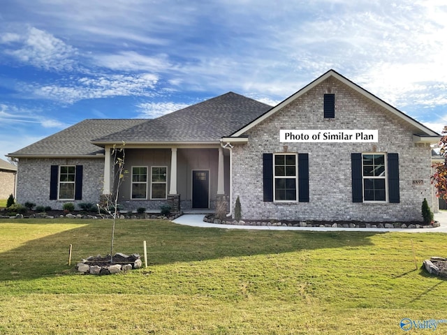 view of front of home featuring roof with shingles and a front lawn