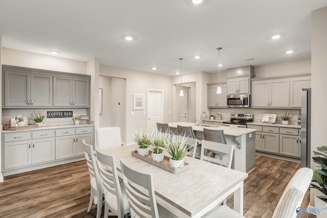 dining room with sink and dark hardwood / wood-style floors