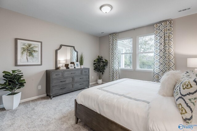 bedroom featuring light carpet