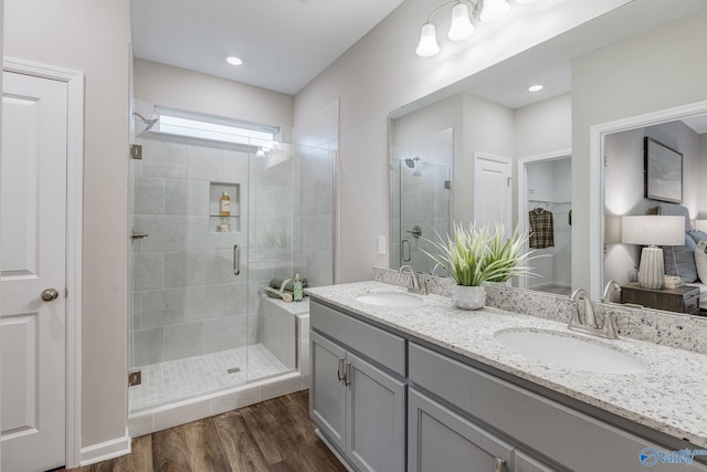 bathroom featuring vanity, hardwood / wood-style flooring, and walk in shower