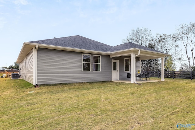 rear view of house featuring a patio area, a yard, and cooling unit