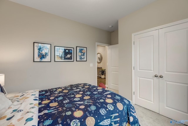 bedroom featuring a closet and light colored carpet