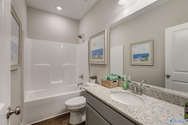 full bathroom featuring hardwood / wood-style floors, vanity,  shower combination, and toilet