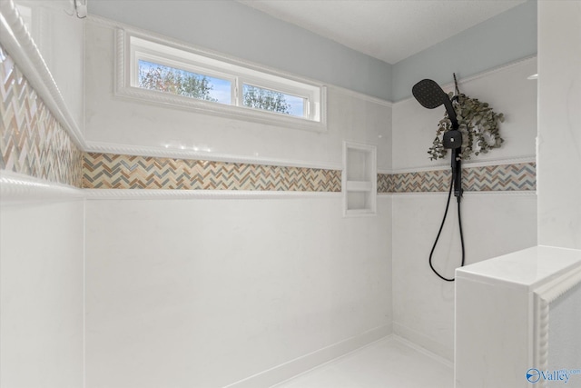 bathroom featuring tile walls and walk in shower