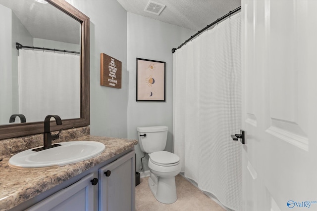 bathroom featuring vanity, a textured ceiling, and toilet