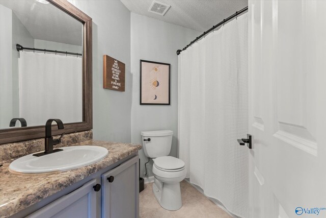 102 Bay Pointe Ln, Madison, AL 35758 - bathroom featuring toilet, vanity, a textured ceiling, tile patterned flooring, and a shower with curtain